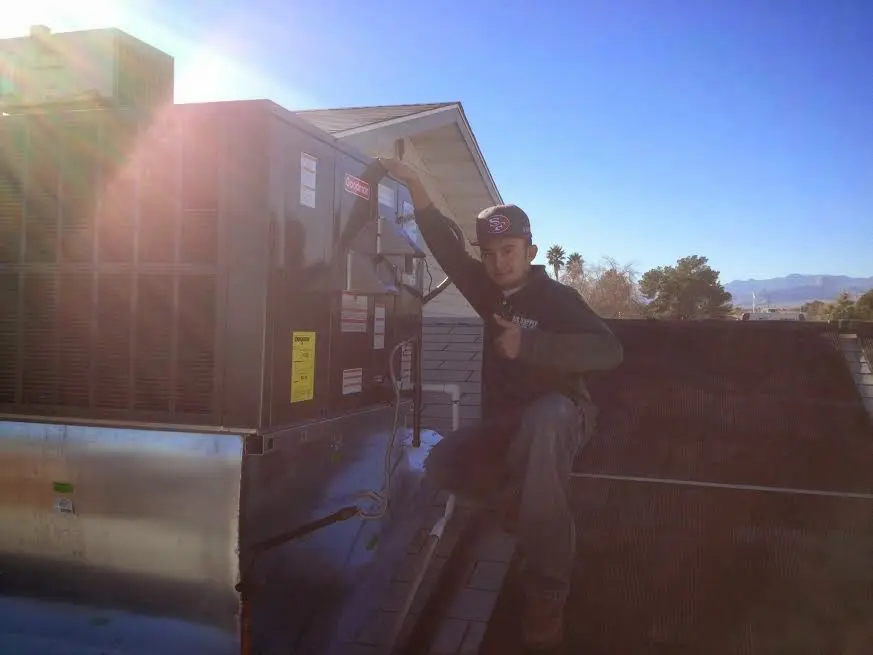 HVAC technician performing AC Tune-Up on a rooftop unit in Stevenson Ranch